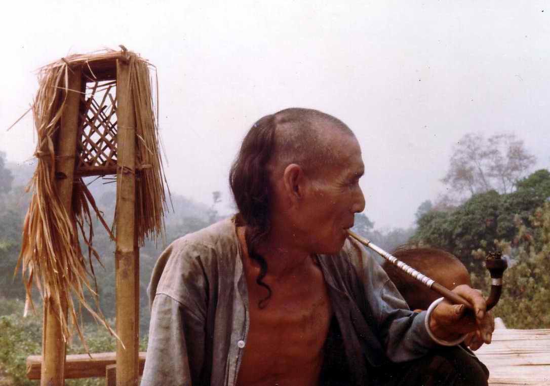 Akha man with opium pipe